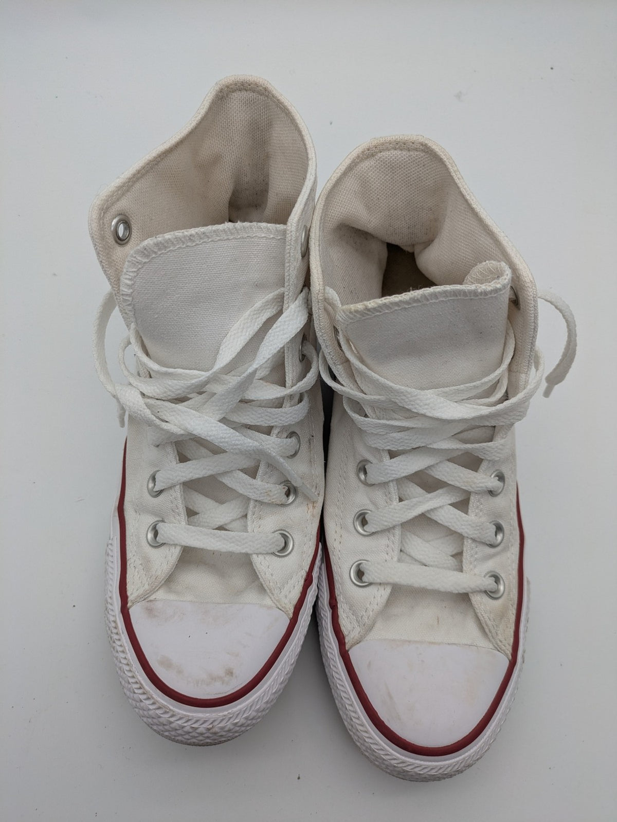Converse Chuck Taylor All Star high top sneakers black canvas with red and white accents.