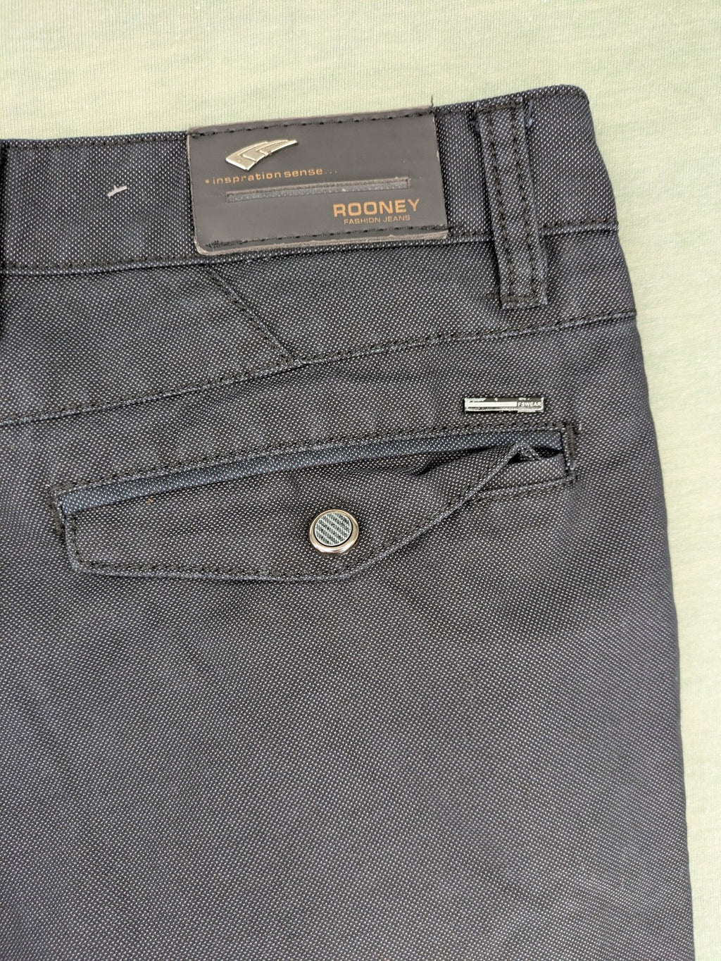 Rooney grey chino pants with checkered waistband and buttoned back pockets.