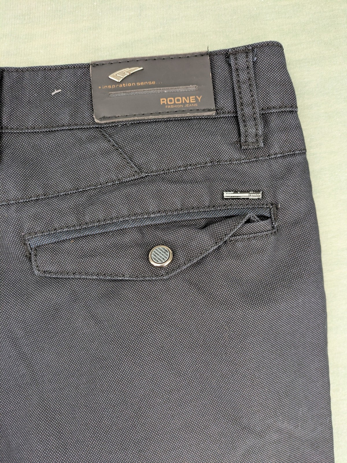 Rooney grey chino pants with checkered waistband and buttoned back pockets.