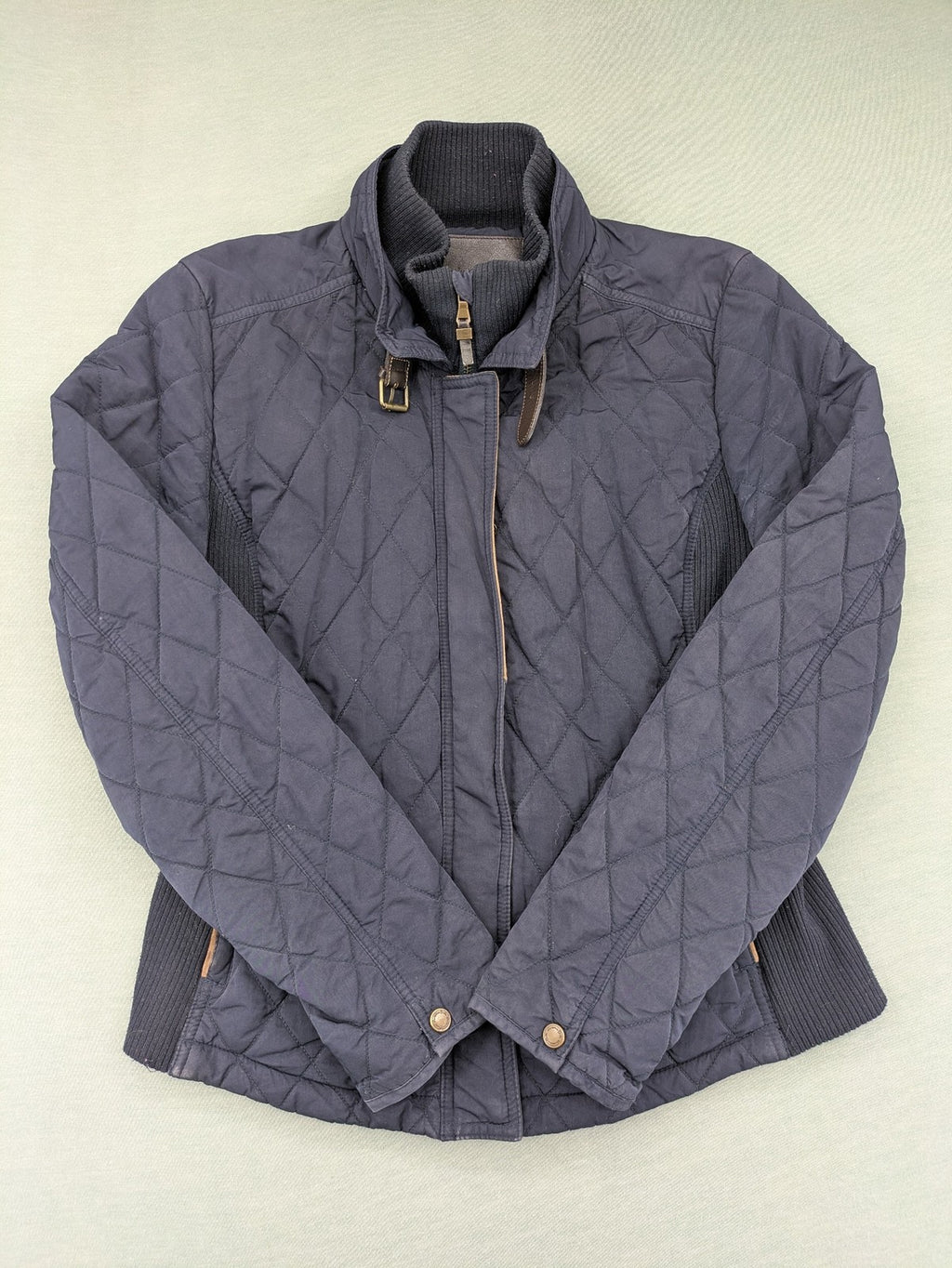 Massimo Dutti black quilted jacket with contrasting brown trim and ribbed side inserts.