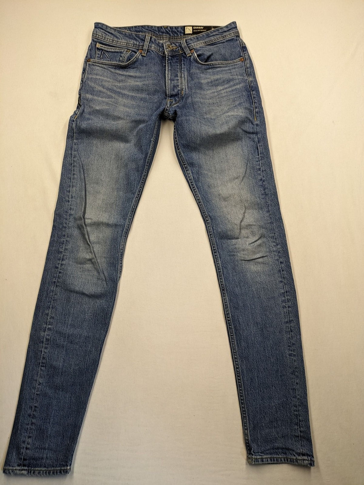 CHASIN' blue slim fit jeans with button fly and classic denim craftsmanship.