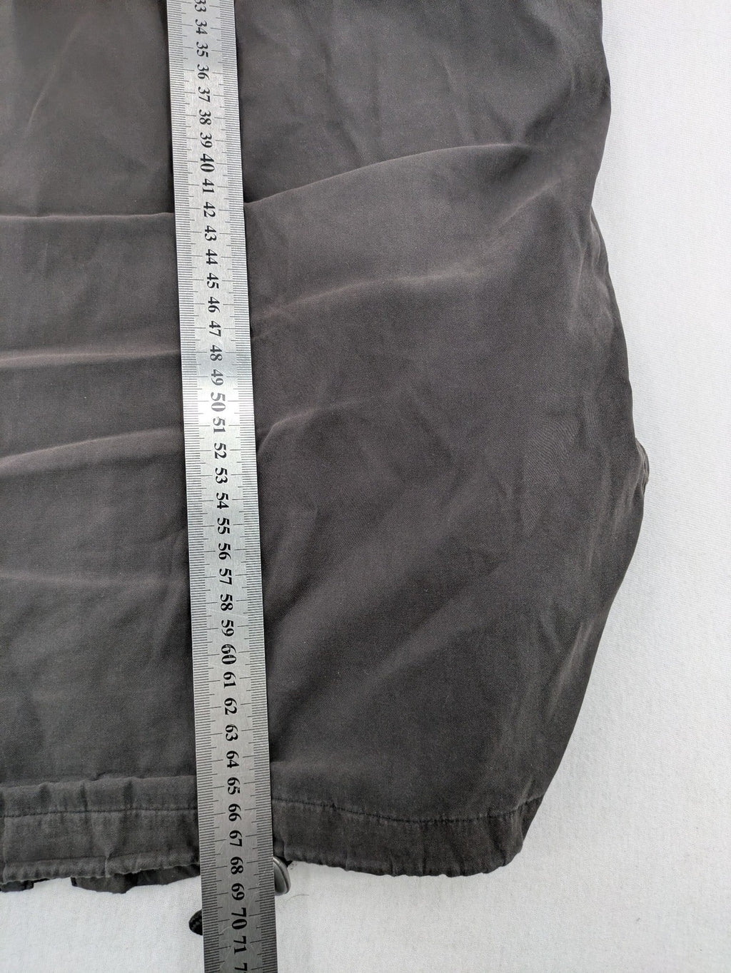 Barisal grey coat with hood, cargo pockets, and checkered lining detail.