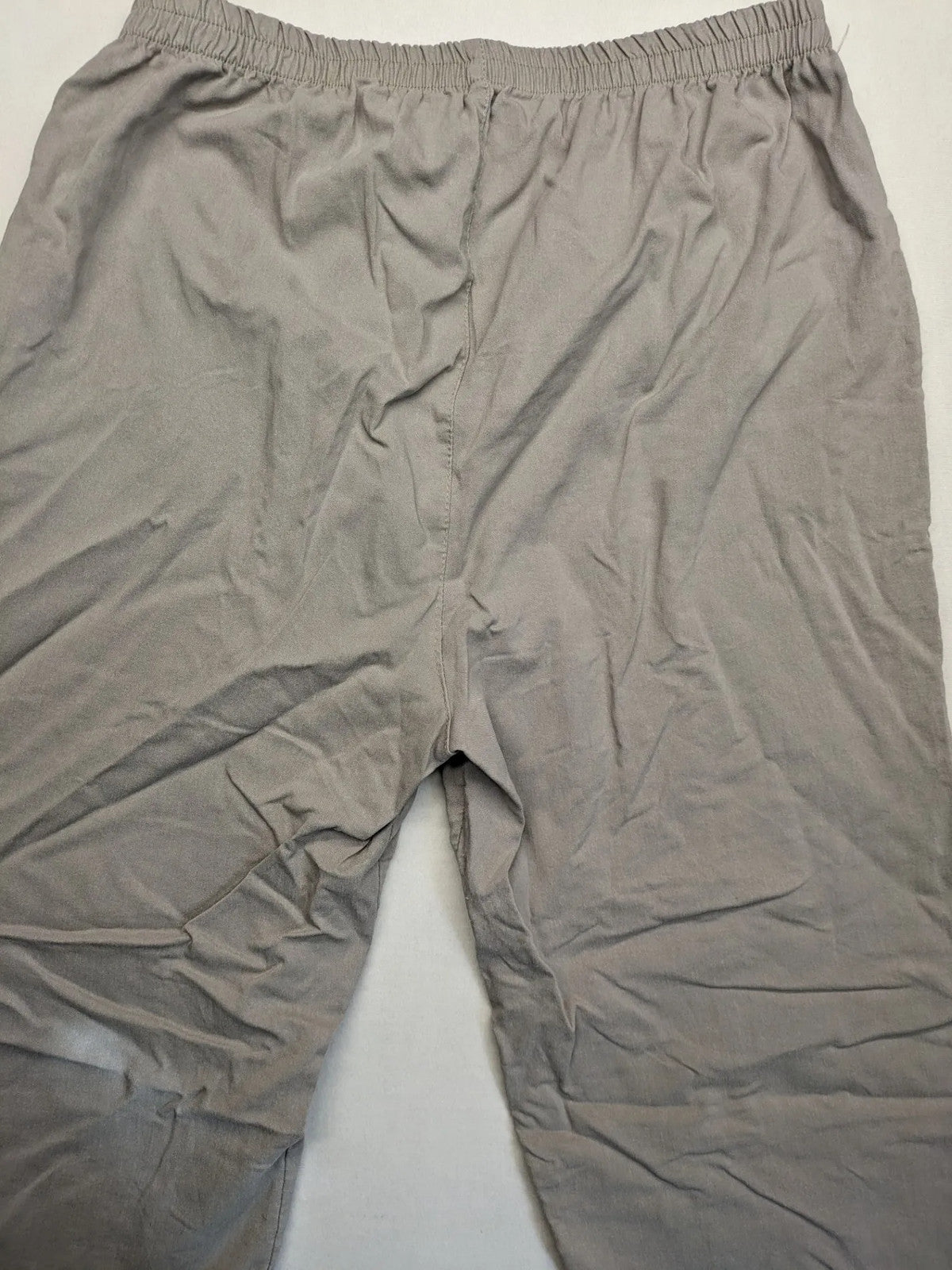 Cherry Berry khaki capri pants with elastic waistband and decorative buttons, featuring logo and zip pockets.