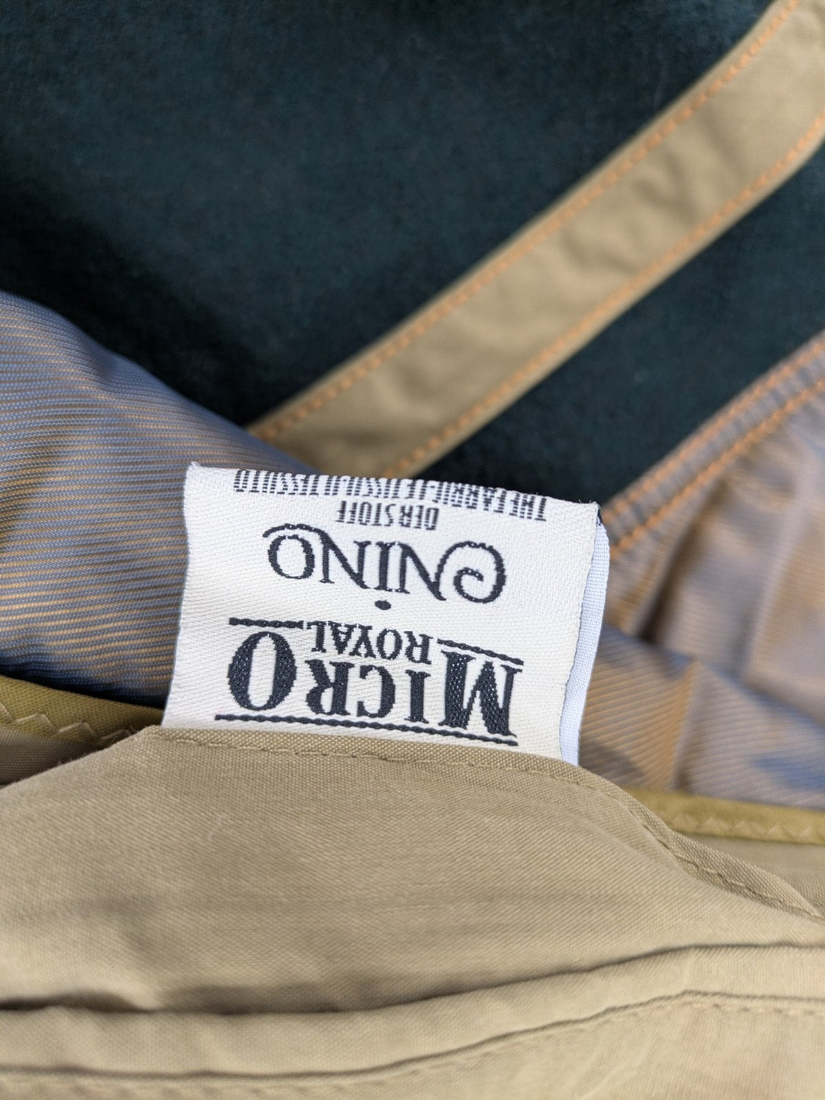 Studio Novum khaki trench coat double-breasted design with belt and wool lining.