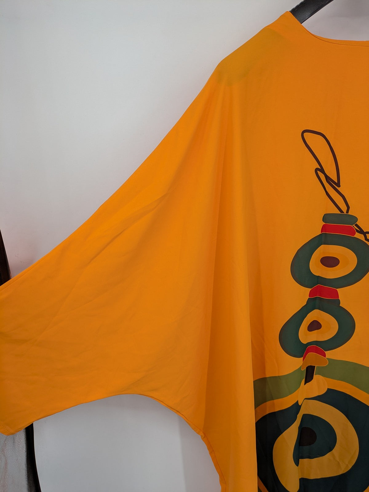 Kaftan orange oversized summer dress with unique graphic print and long sleeves.