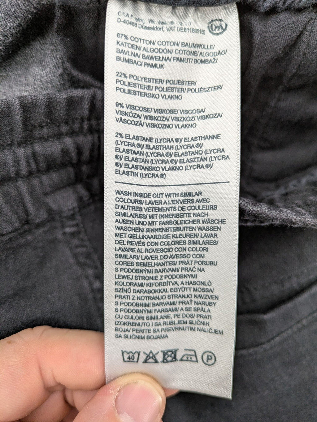 C&A grey jogger pants with elastic cuffs, drawstring waist, and multiple pockets.