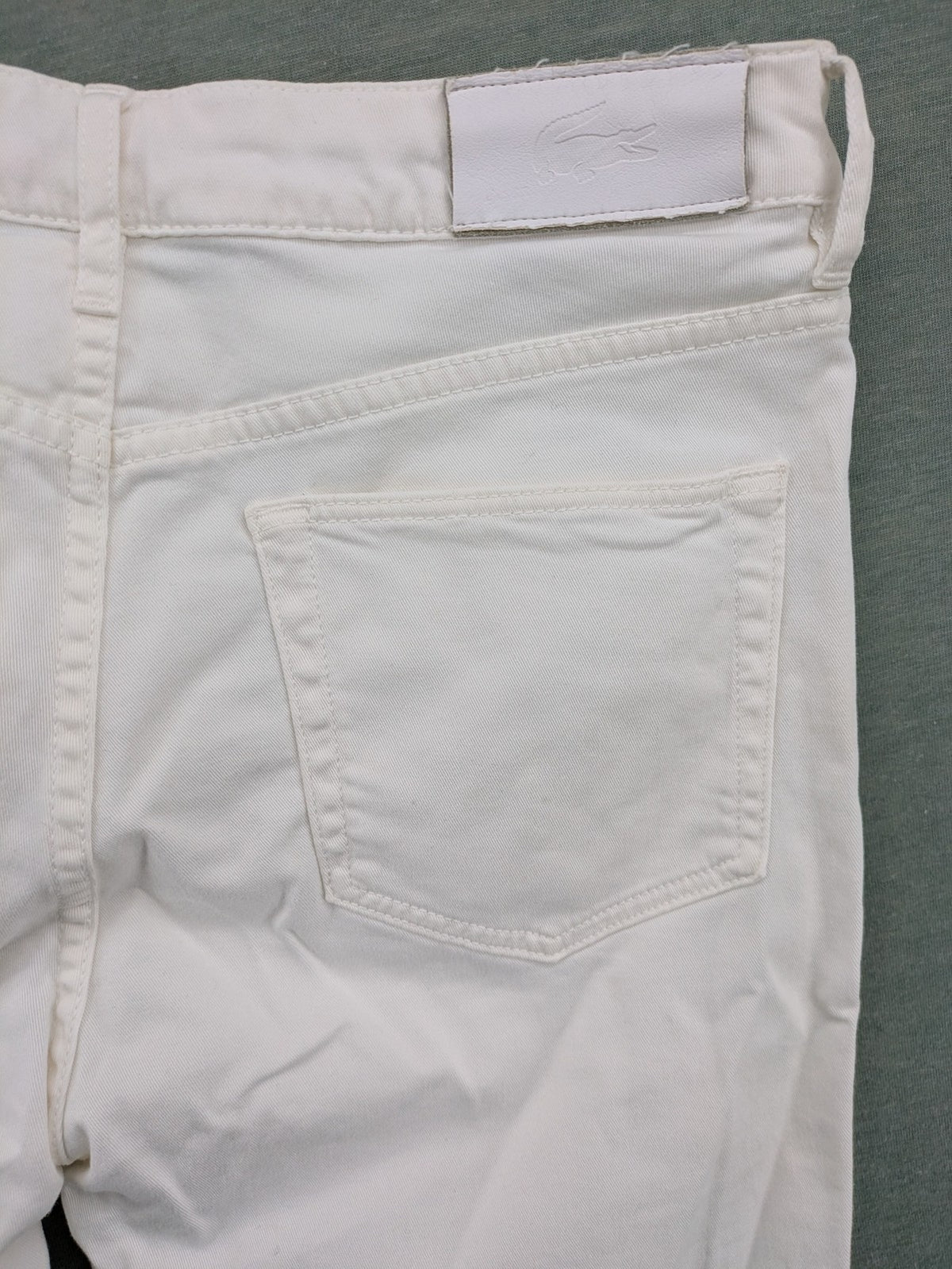 Lacoste white straight jeans high rise slim fit with logo and stretch denim material.