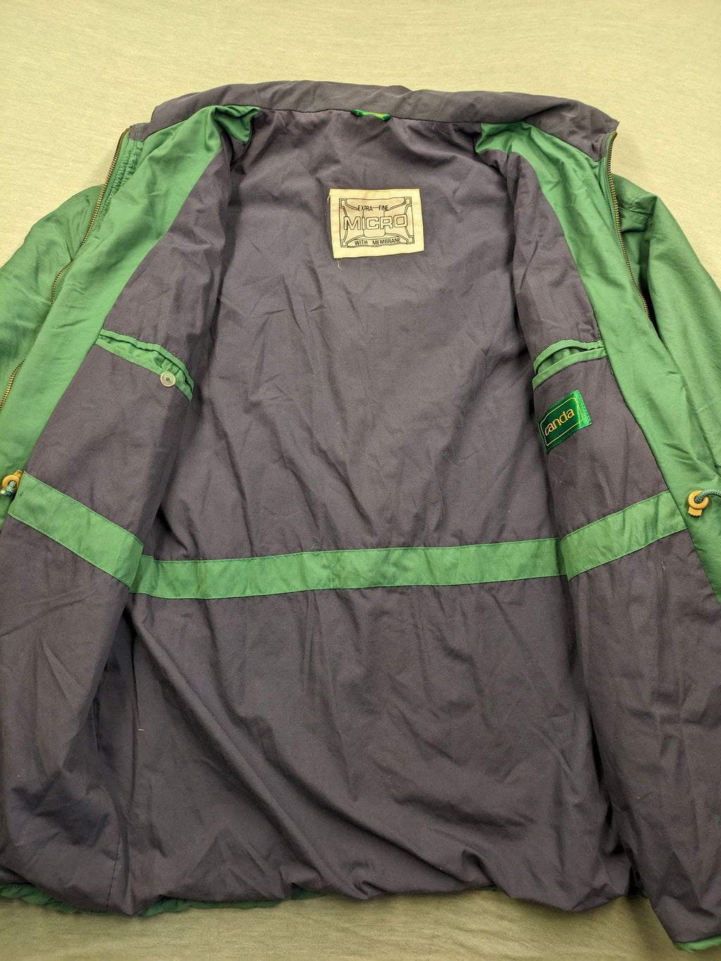 Canda green parka coat with dark lining, multiple pockets, and Micro Membrane technology.
