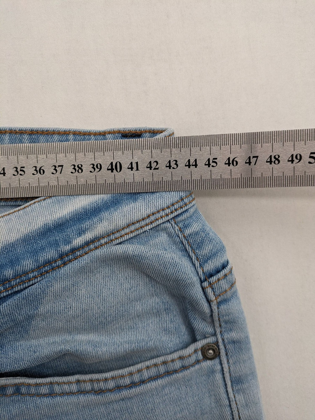 i8 Denim blue straight jeans destroyed look with frayed hems and classic button fly.