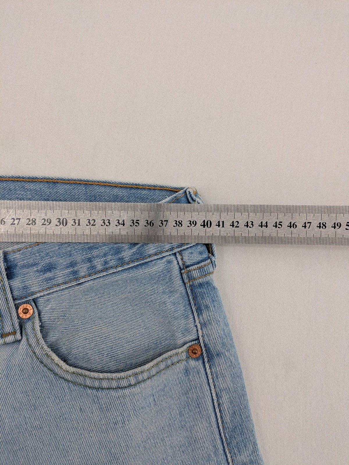 Levi's blue straight jeans light wash denim with button fly and classic fit.