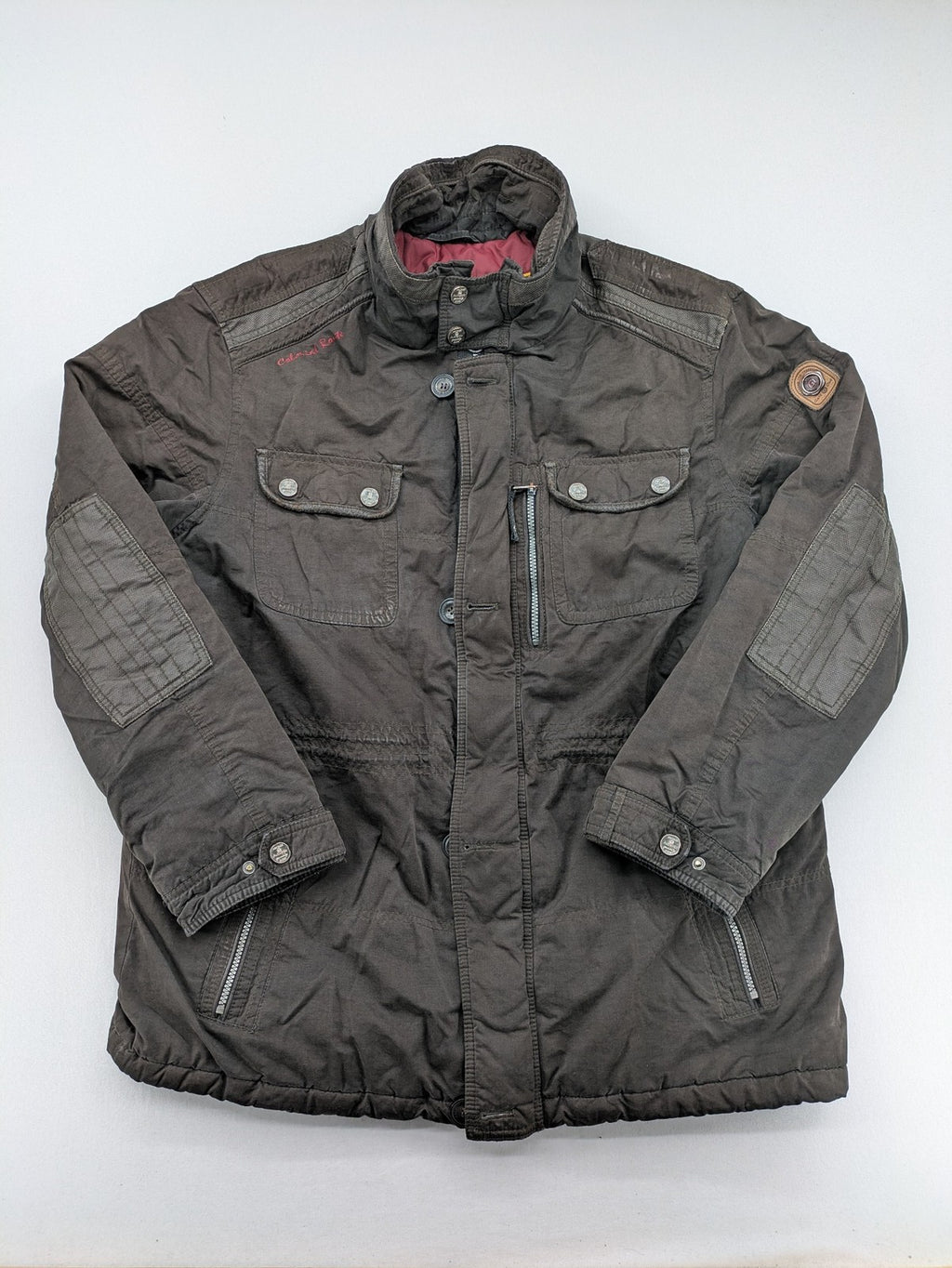 Gate One brown field jacket with plaid lining, multiple pockets, and zip-button closure.