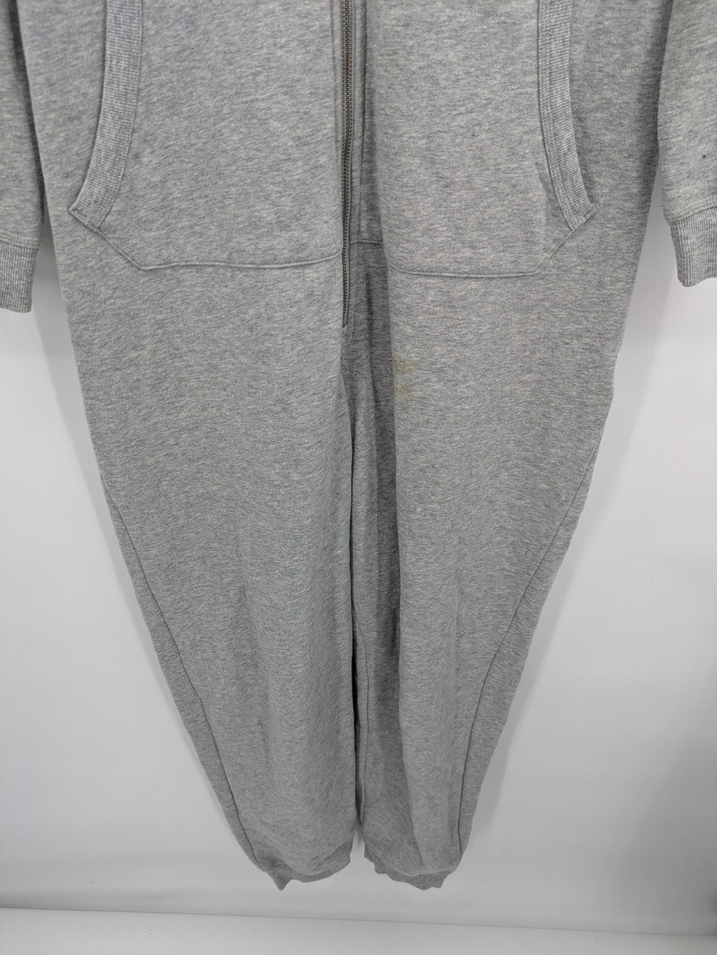 ESMARA cream jumpsuit with hood, graphic print, and front zipper, soft material.