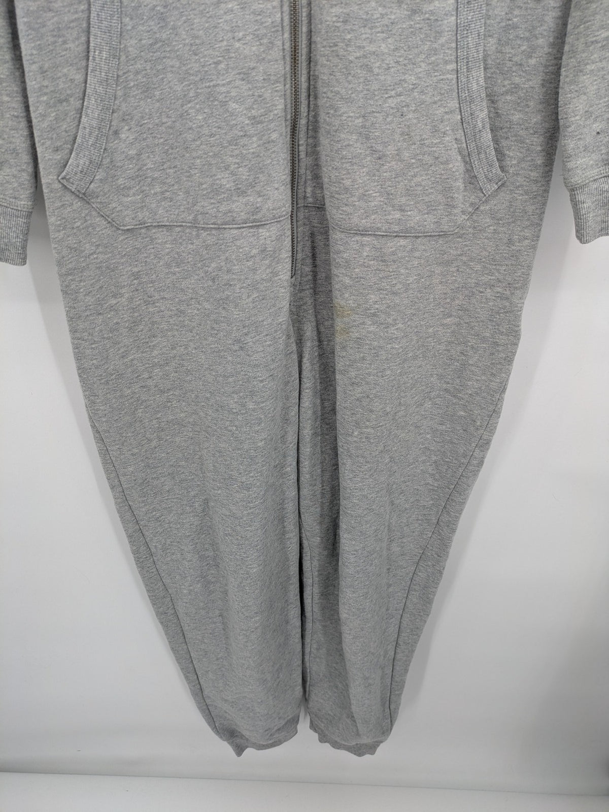 ESMARA cream jumpsuit with hood, graphic print, and front zipper, soft material.