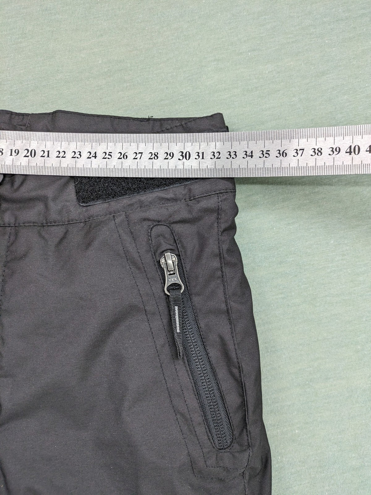 Wed'ze black ski pants with adjustable waistband, zip pockets, and Pull'n'Fit system.