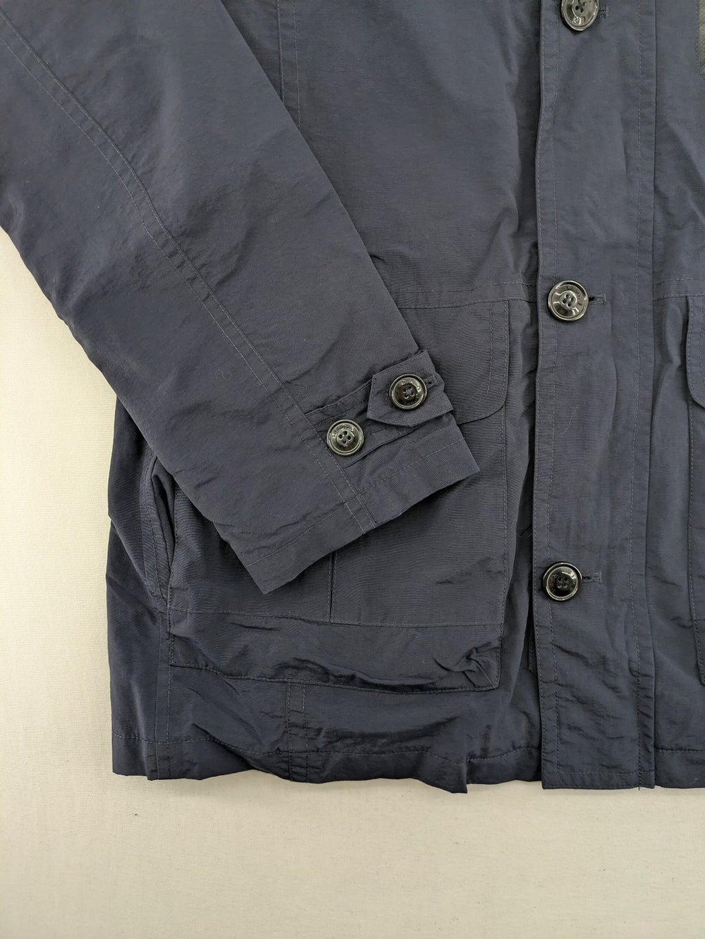 Reset navy parka jacket windproof with adjustable hood and zippered chest pocket.