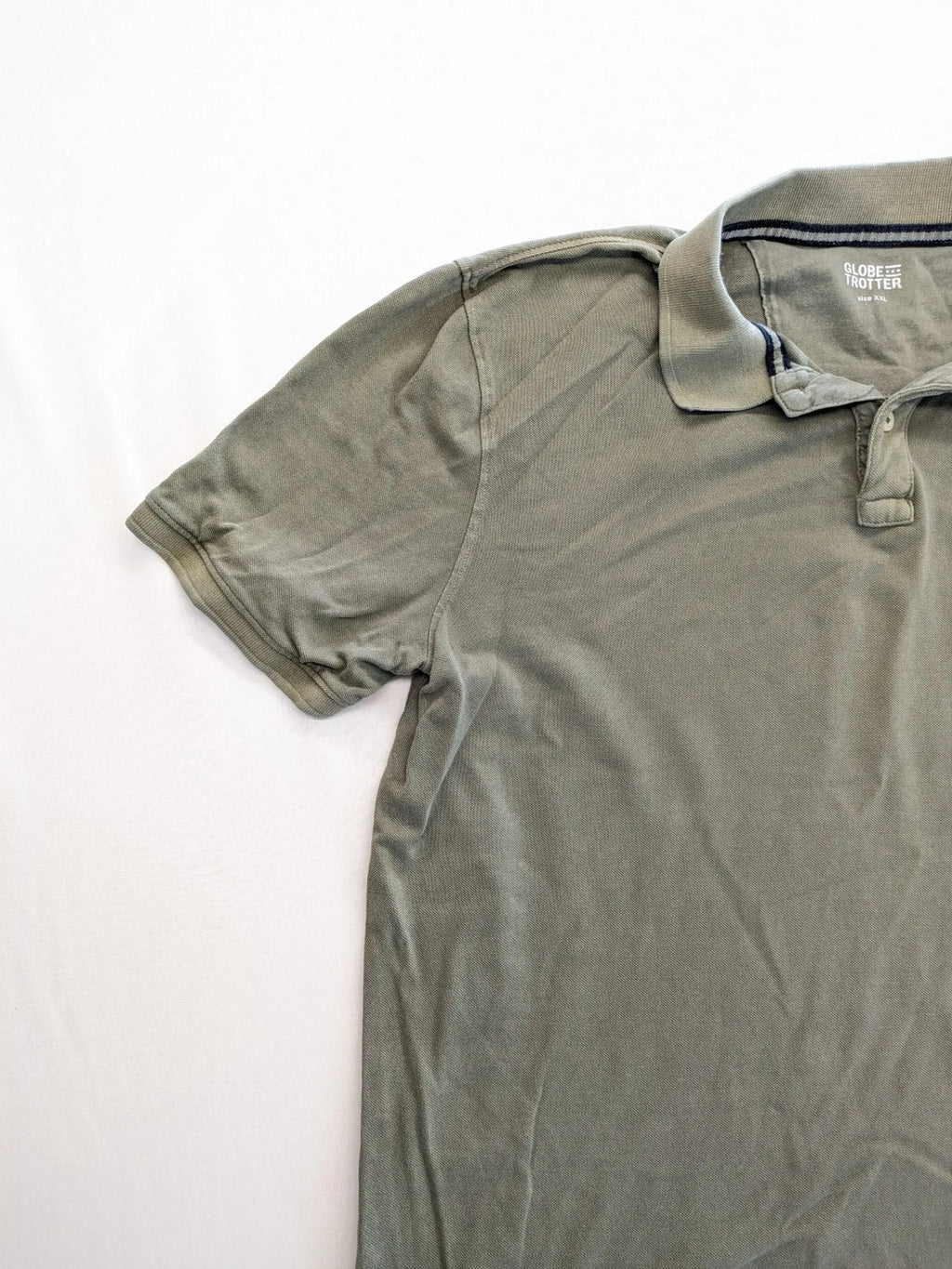 Globe-Trotter beige khaki polo shirt with classic collar and small chest logo.