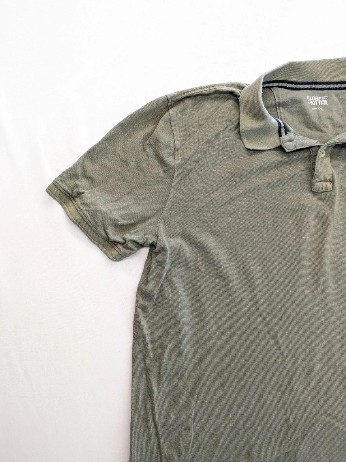 Globe-Trotter beige khaki polo shirt with classic collar and small chest logo.