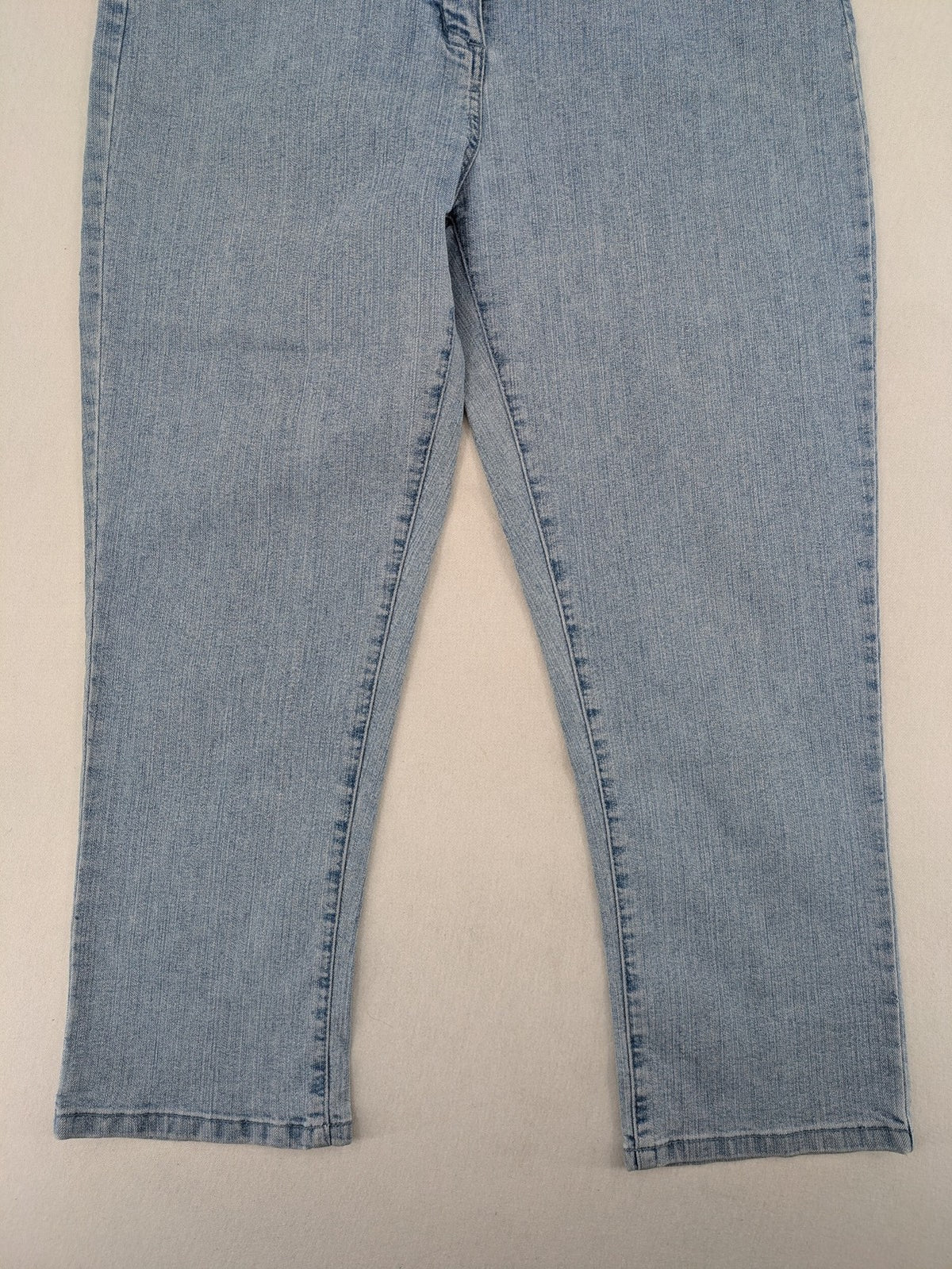 Capri blue straight jeans with 5-pocket design and embroidered details on back pockets.