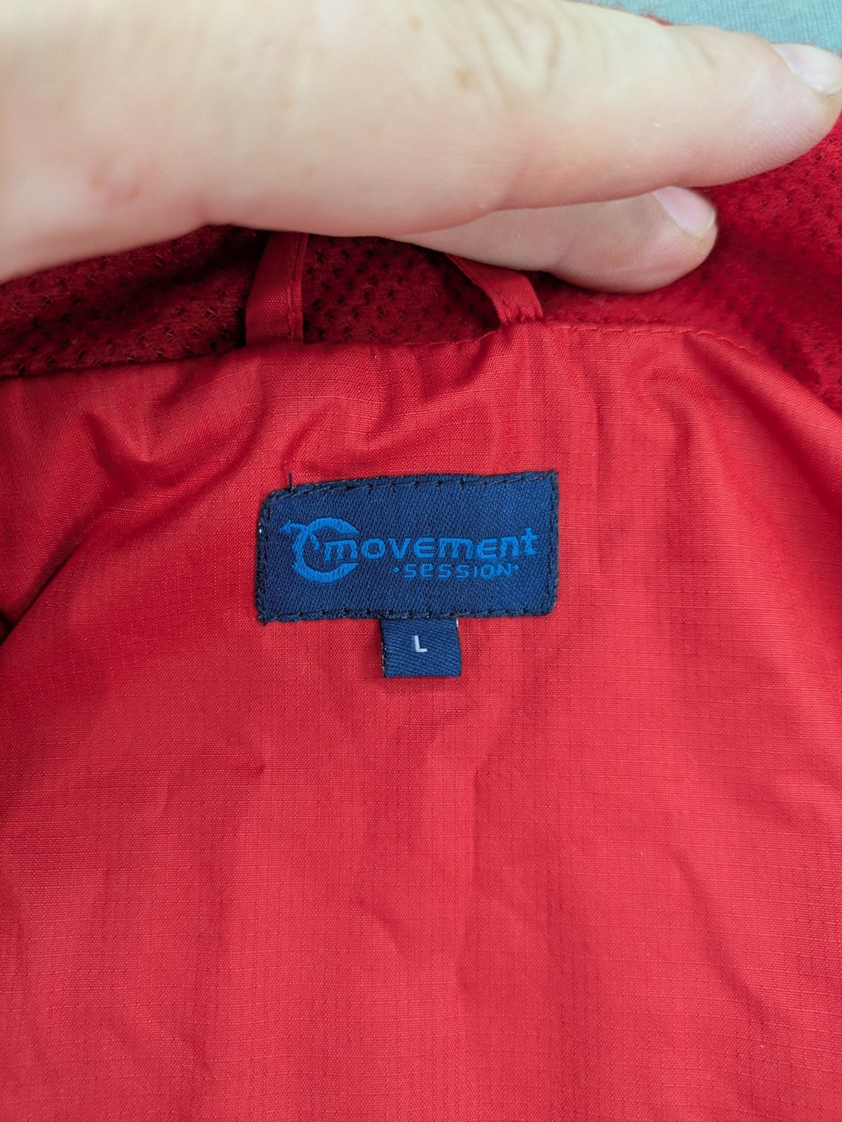 Movement Session grey and red windbreaker jacket with colorblock pattern and full zip.