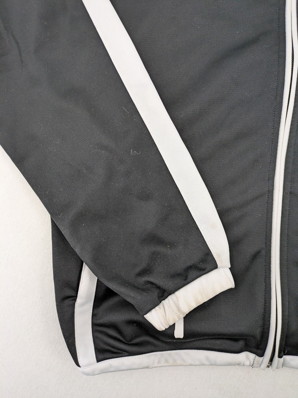 Spalding black training jacket with orange and white accents, Rasta Vechta logo, zip front.