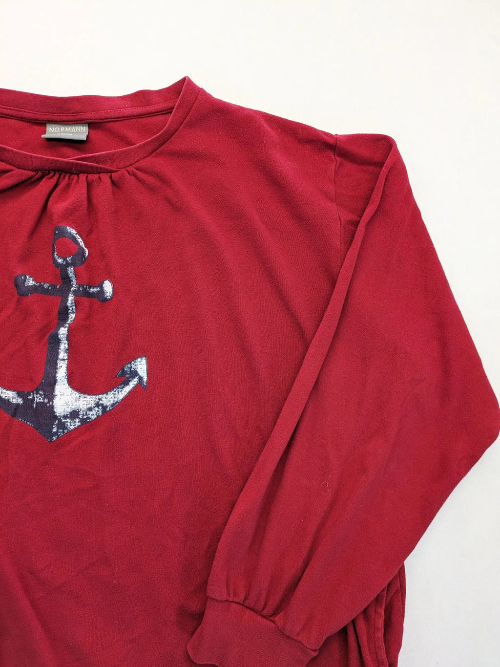 Normann red turtle neck jumper with large anchor print and side pockets.