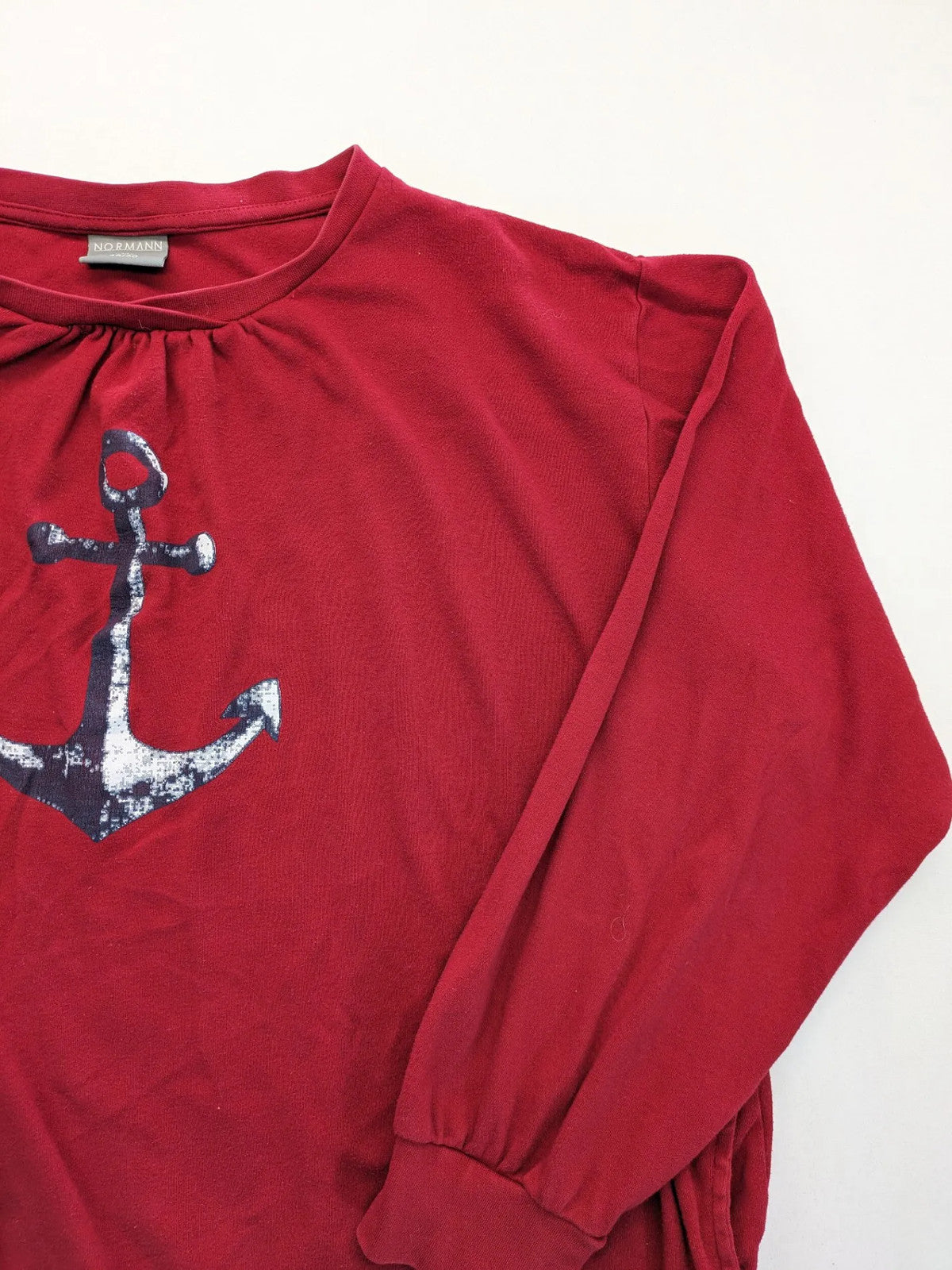 Normann red turtle neck jumper with large anchor print and side pockets.