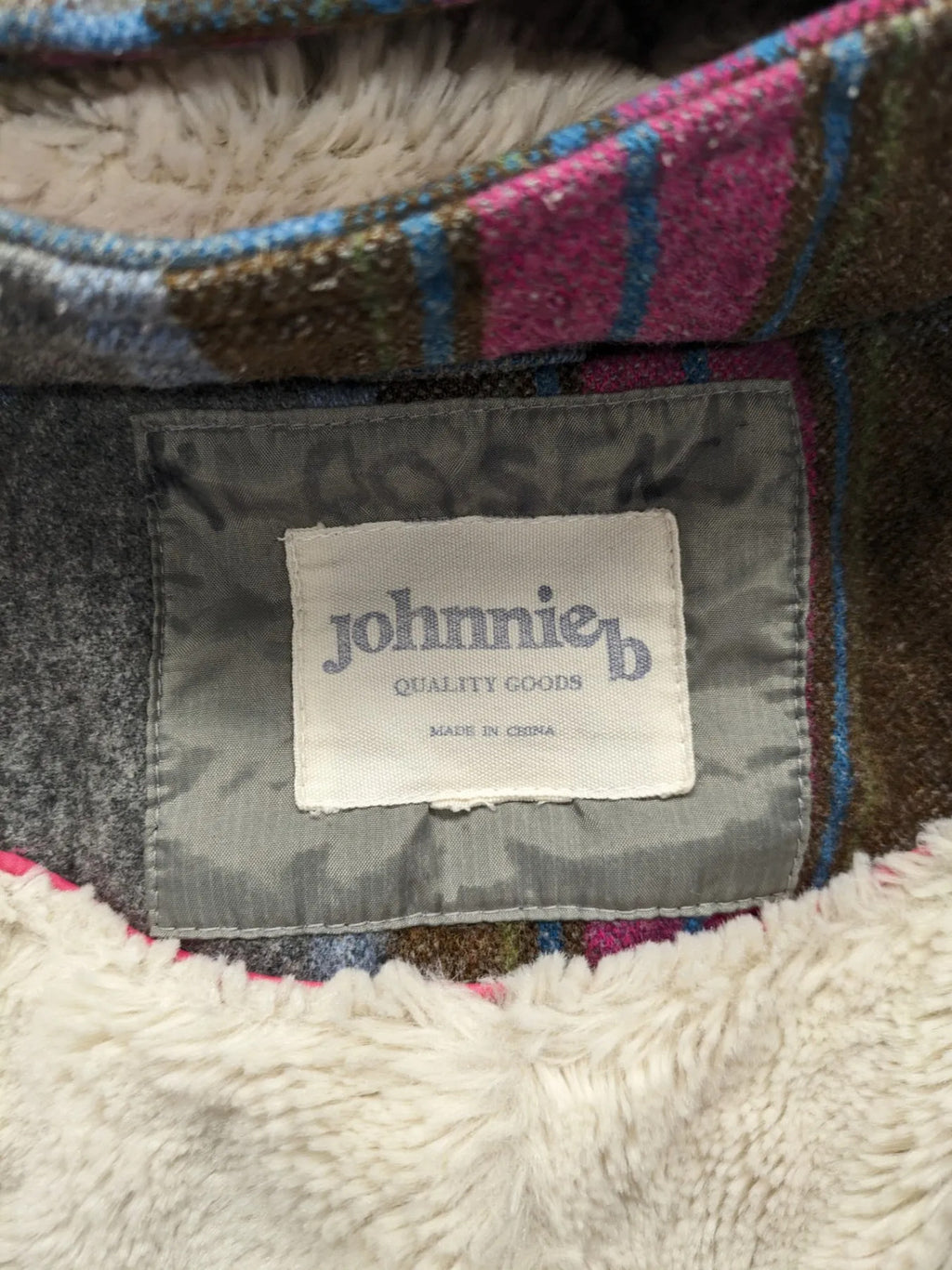 Johnnie B pink coat with gray check pattern, Sherpa lining, and zip closure.