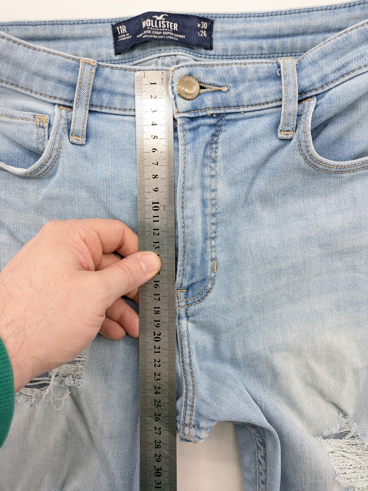 Hollister blue high-rise crop super skinny jeans with distressed rips and frayed hem.