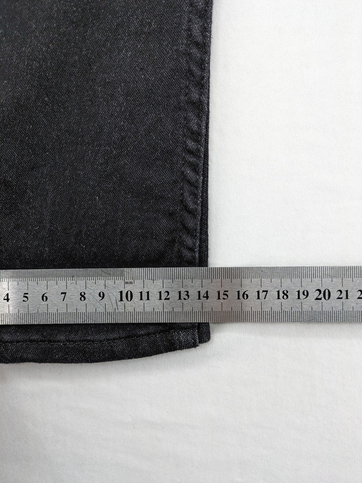 Skinny black straight jeans with distressed details and logo, made from durable denim.