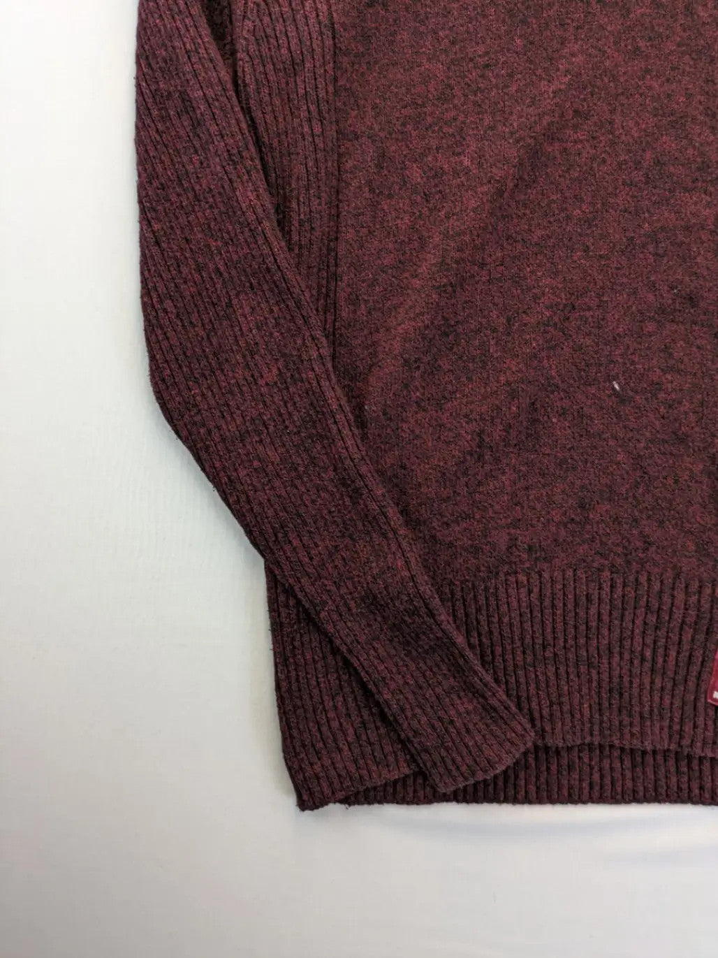 Infinity burgundy turtle neck jumper with quarter-zip and ribbed knit texture.