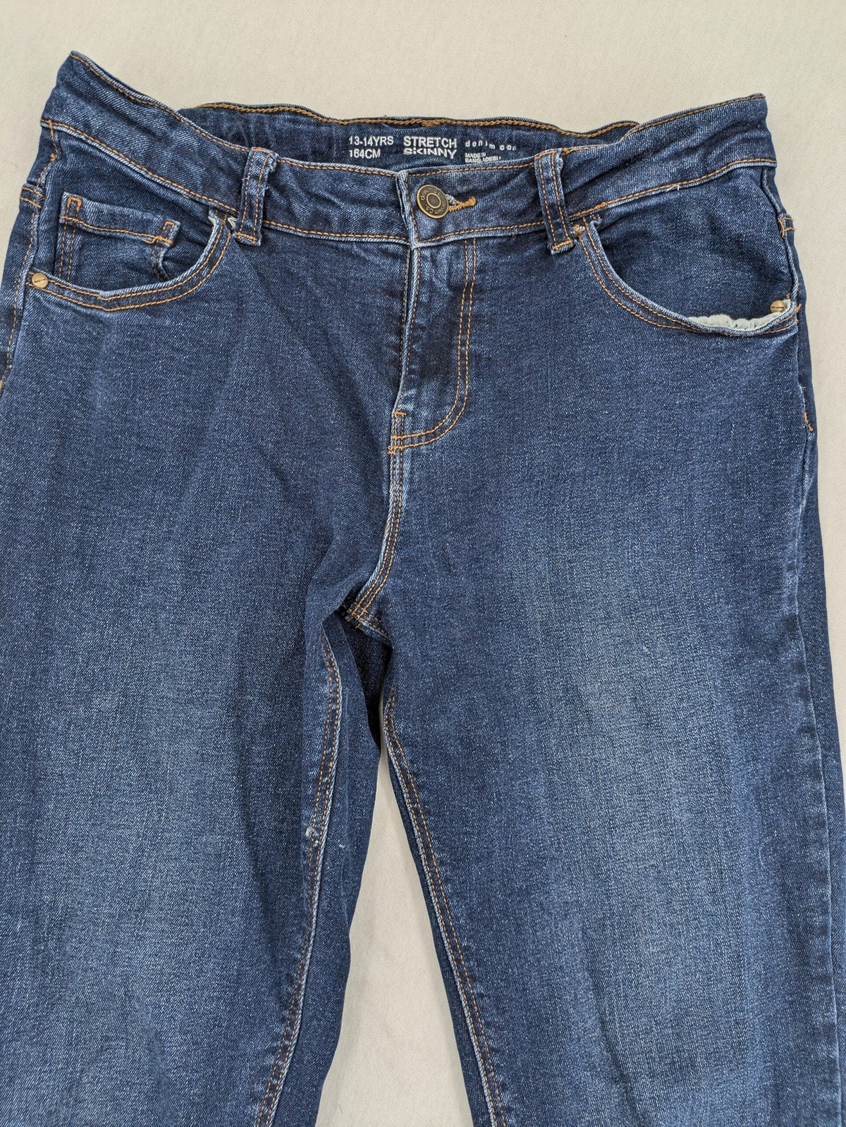 Denim & Co. blue skinny stretch jeans, five-pocket design, dark wash, durable material.