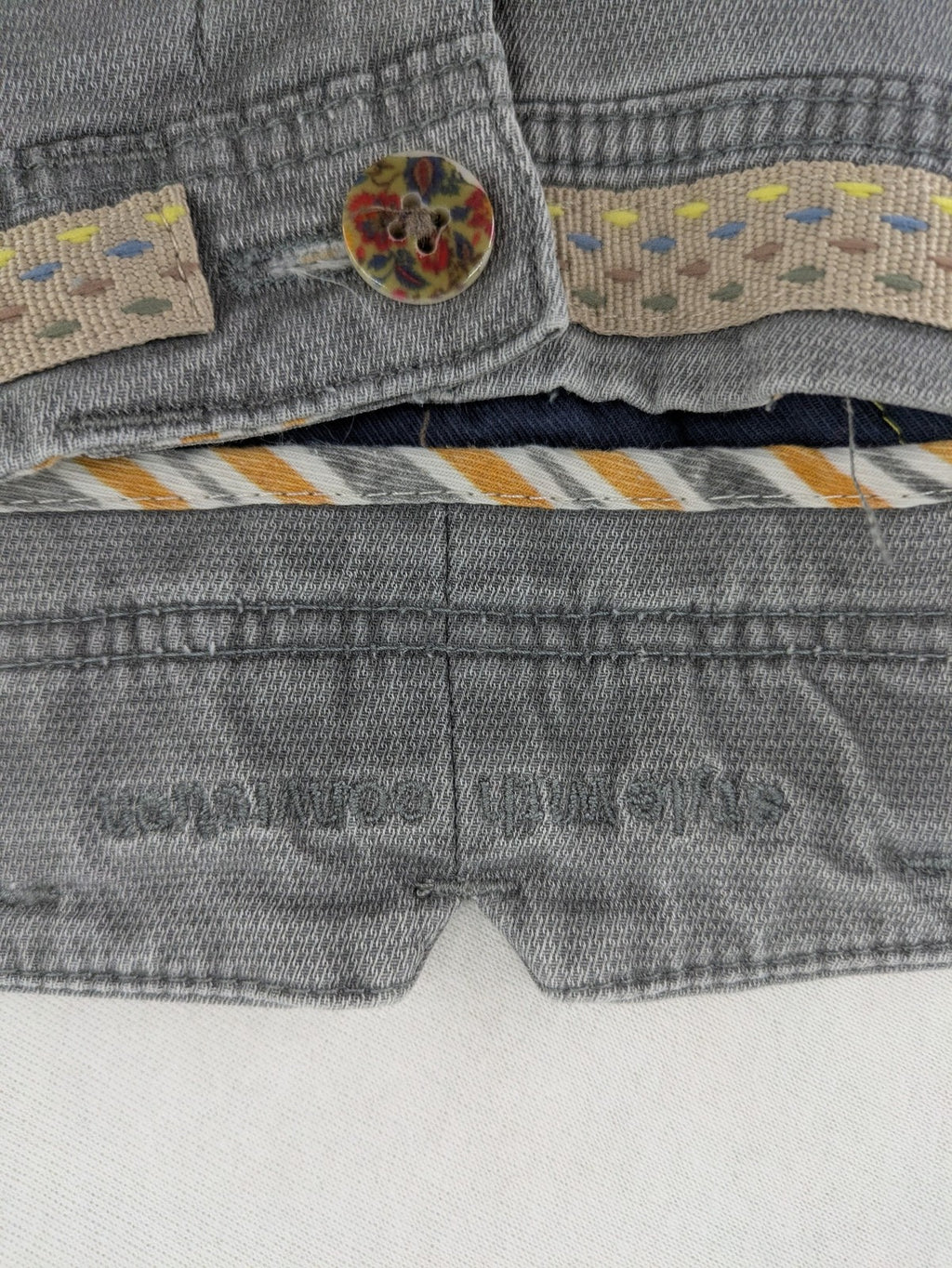 MMX grey chino pants with patterned interior lining and contrasting waistband, made from organic cotton.
