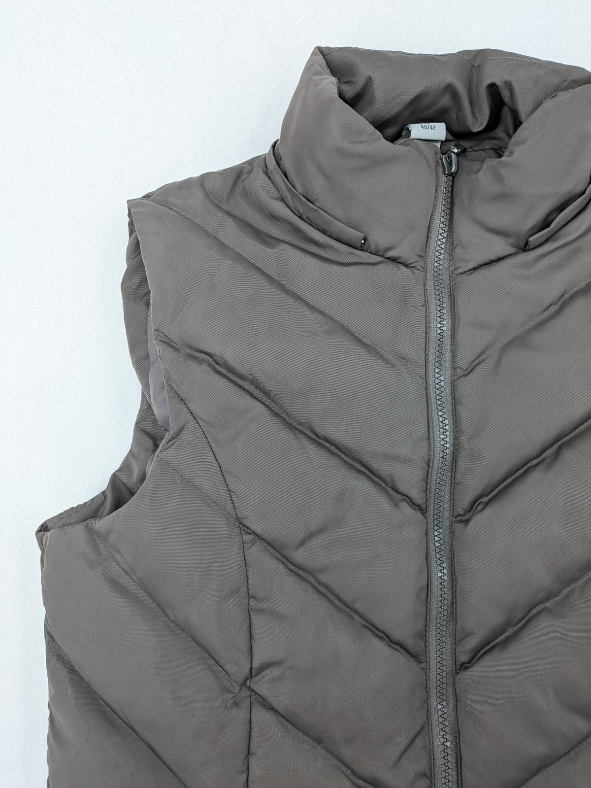 L&A Fashion grey puffer vest with zip closure, stand collar, and side pockets.