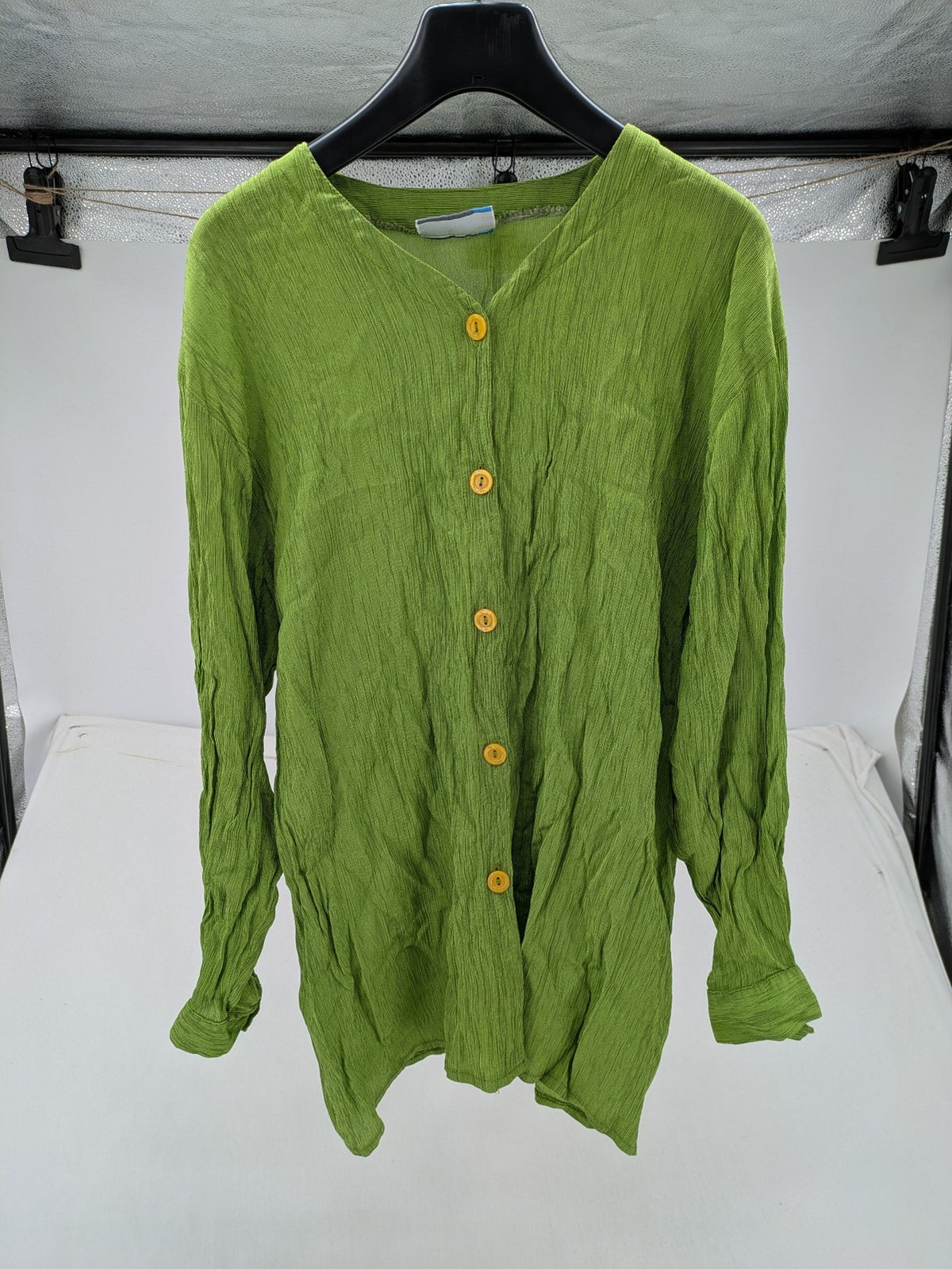 Expressions green blouse with V-neck, button front, and crinkle texture.