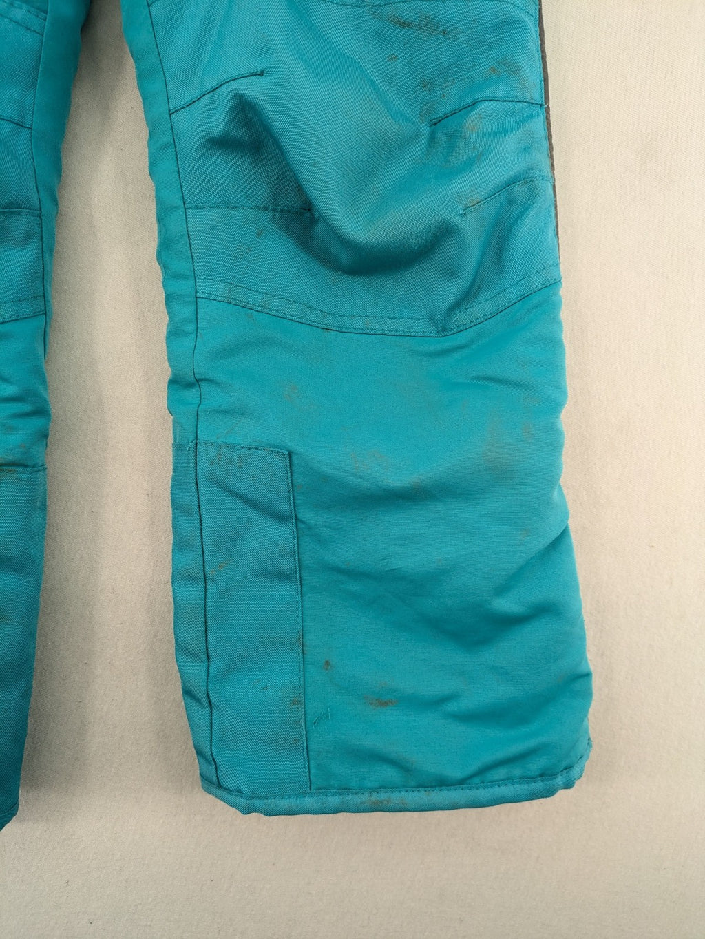 Topolino blue and turquoise snow pants with adjustable straps and fleece-lined bib.