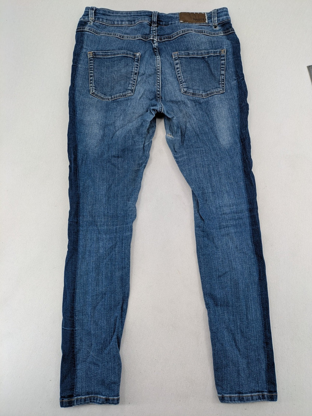 Yessica blue skinny jeans with two-tone side stripe and classic five-pocket design.
