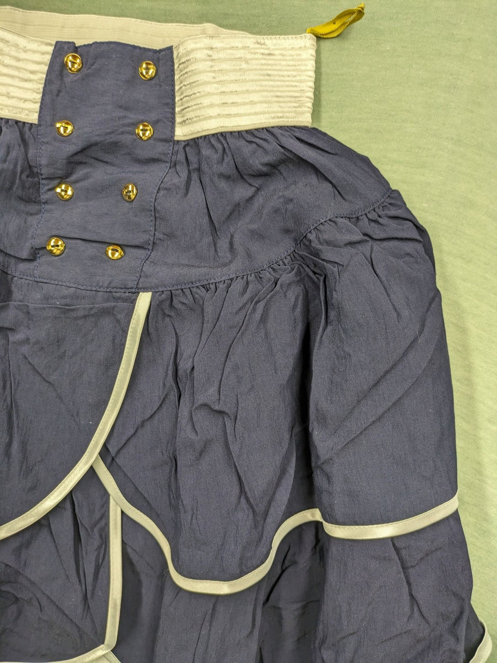 C&A knee-length skirt cream and navy, high waist with tiered ruffles and gold buttons.