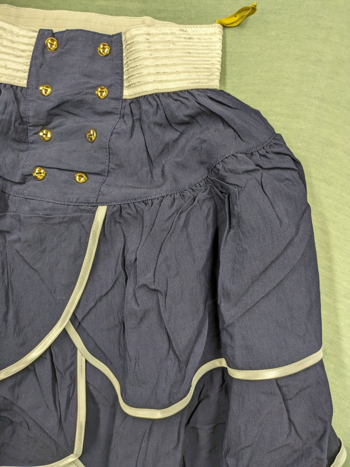 C&A knee-length skirt cream and navy, high waist with tiered ruffles and gold buttons.