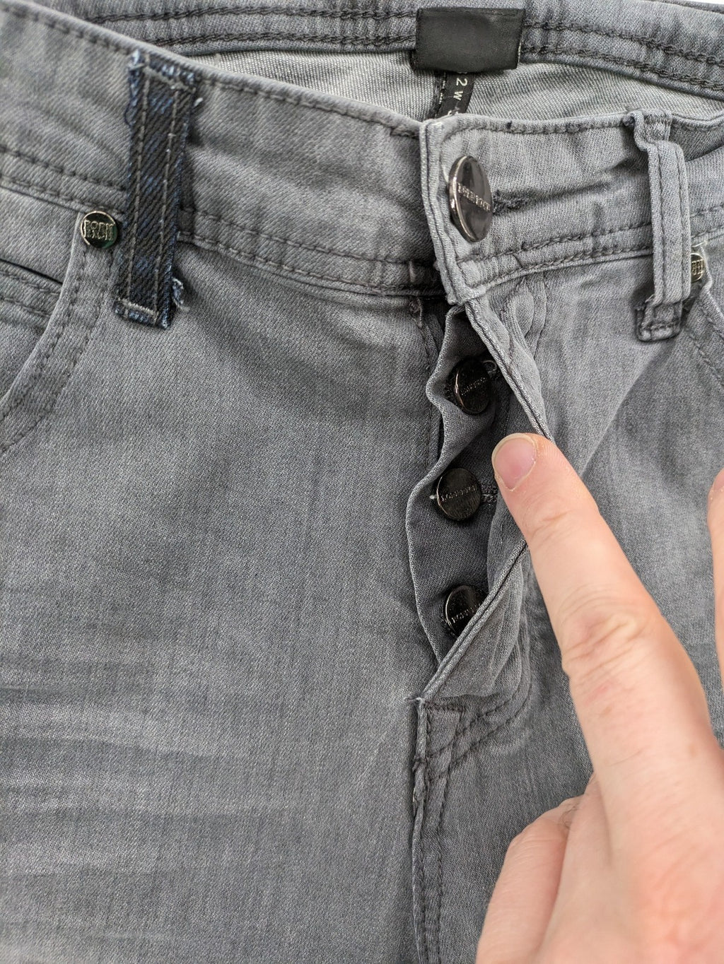Born Rich grey slim fit jeans with button fly and washed denim texture.