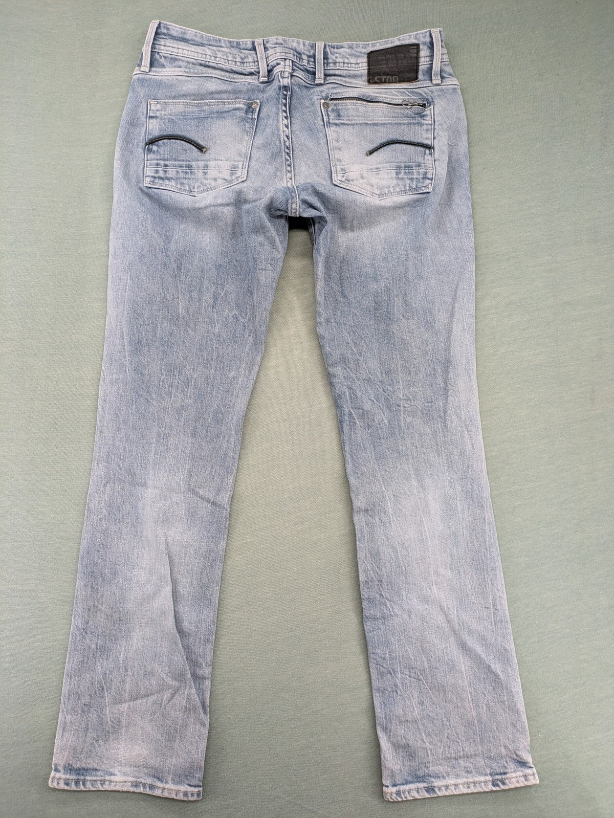 G-Star Raw blue straight leg jeans with classic 5-pocket design and light wash denim.