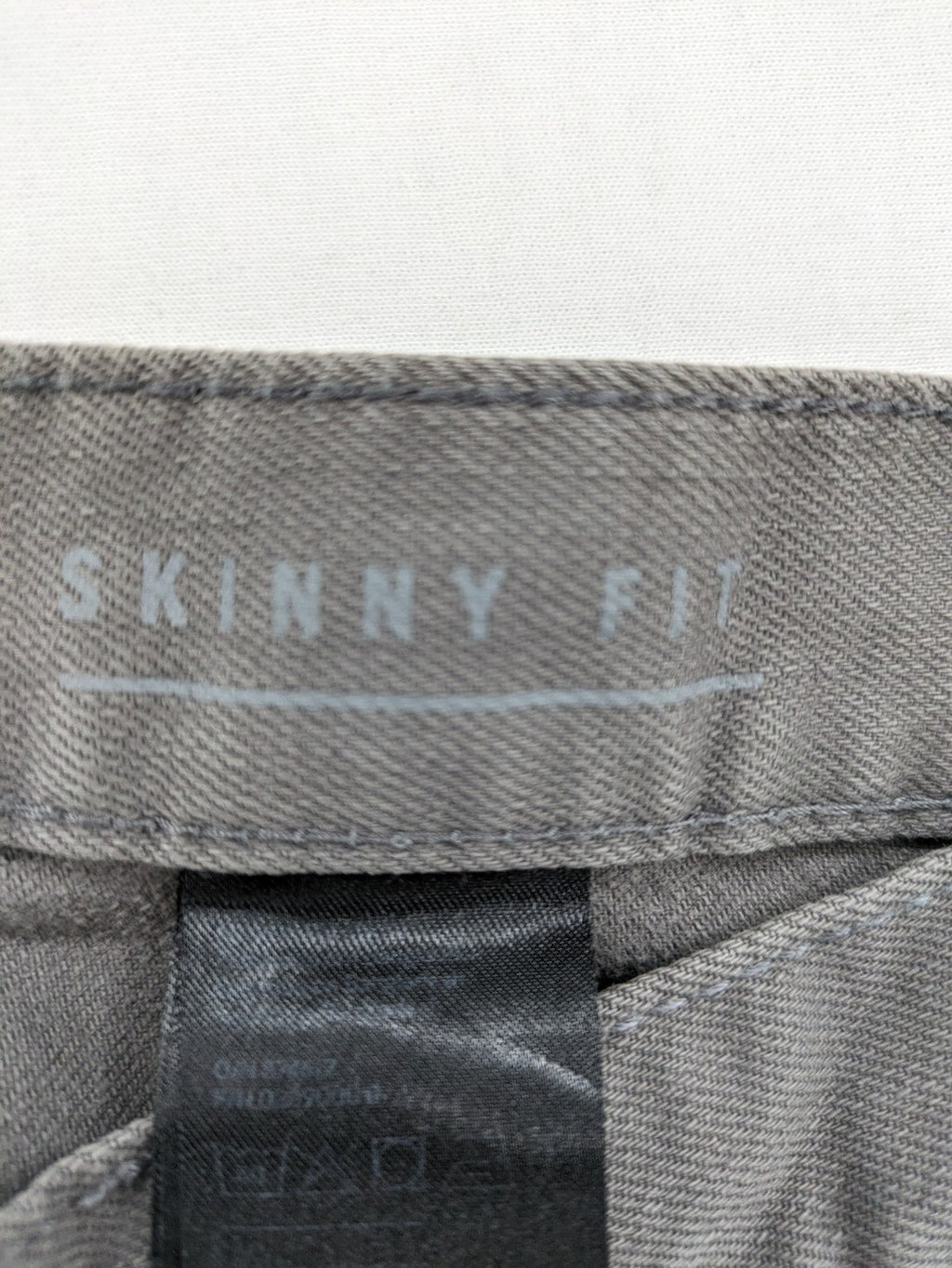 H&M grey skinny fit jeans with button closure and five-pocket design, cotton-elastane blend.