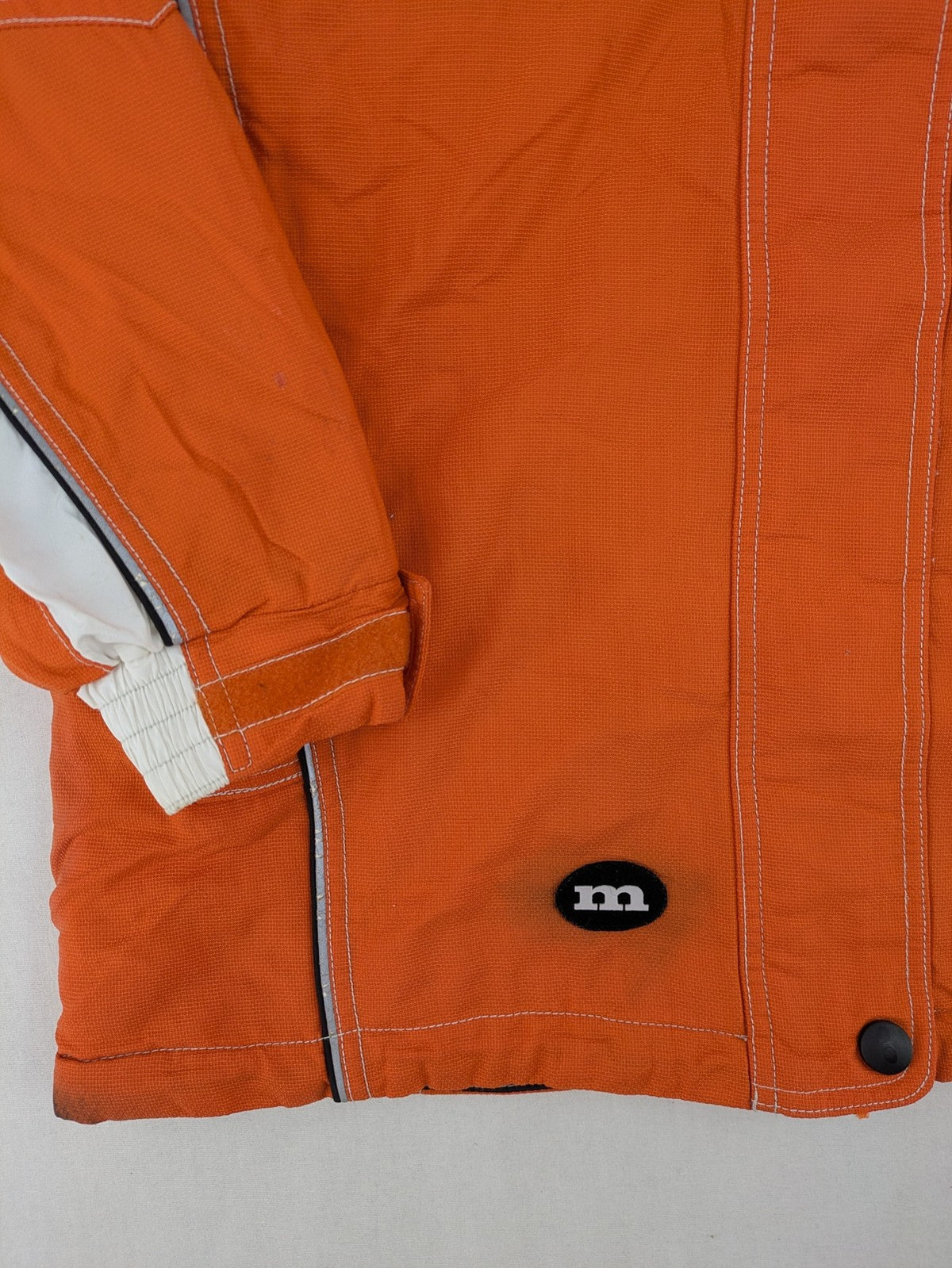Outback orange outdoor jacket size 42 with reflective accents and mixed color details.