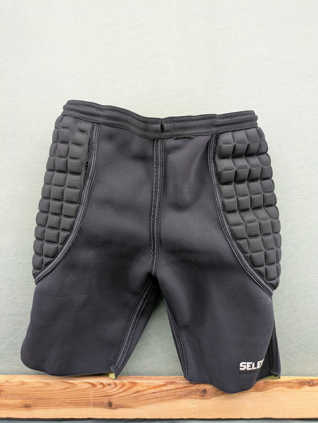 Select padded goalkeeper shorts black with robust hip and tailbone padding.