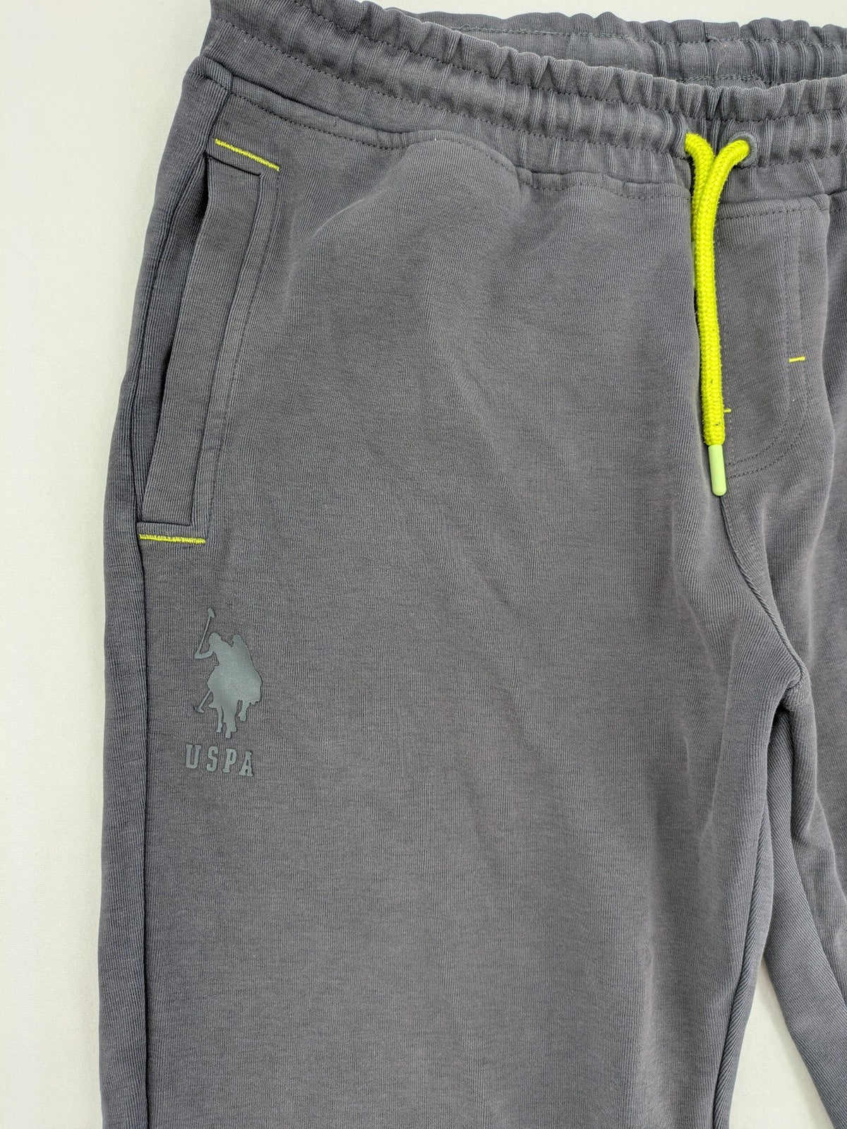 US Polo Assn grey sweatpants with light green drawstring and subtle logo detail.