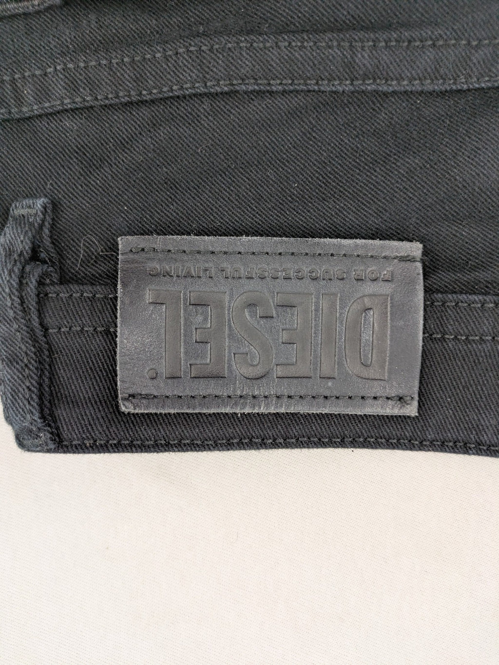 Diesel black Thommer Slim jeans with classic 5-pocket design and stretch material.