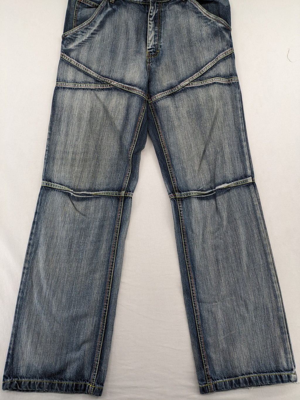 Identic orange straight jeans with paneled design and contrasting yellow stitching.