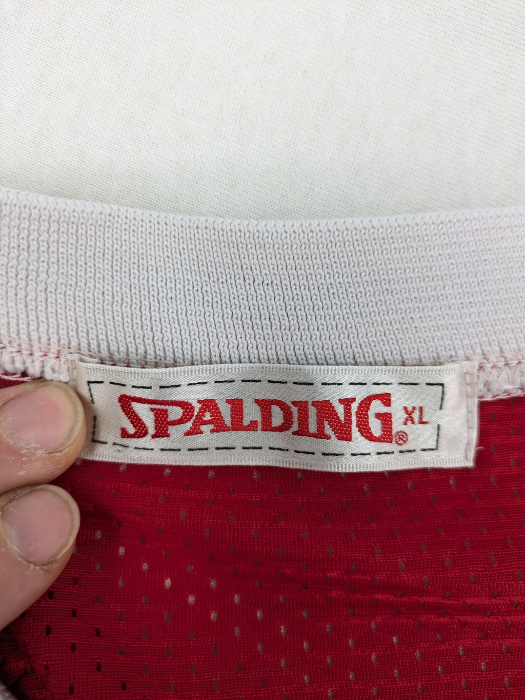 Spalding vintage red basketball jersey size XL, number 11, with black and white striped trim.