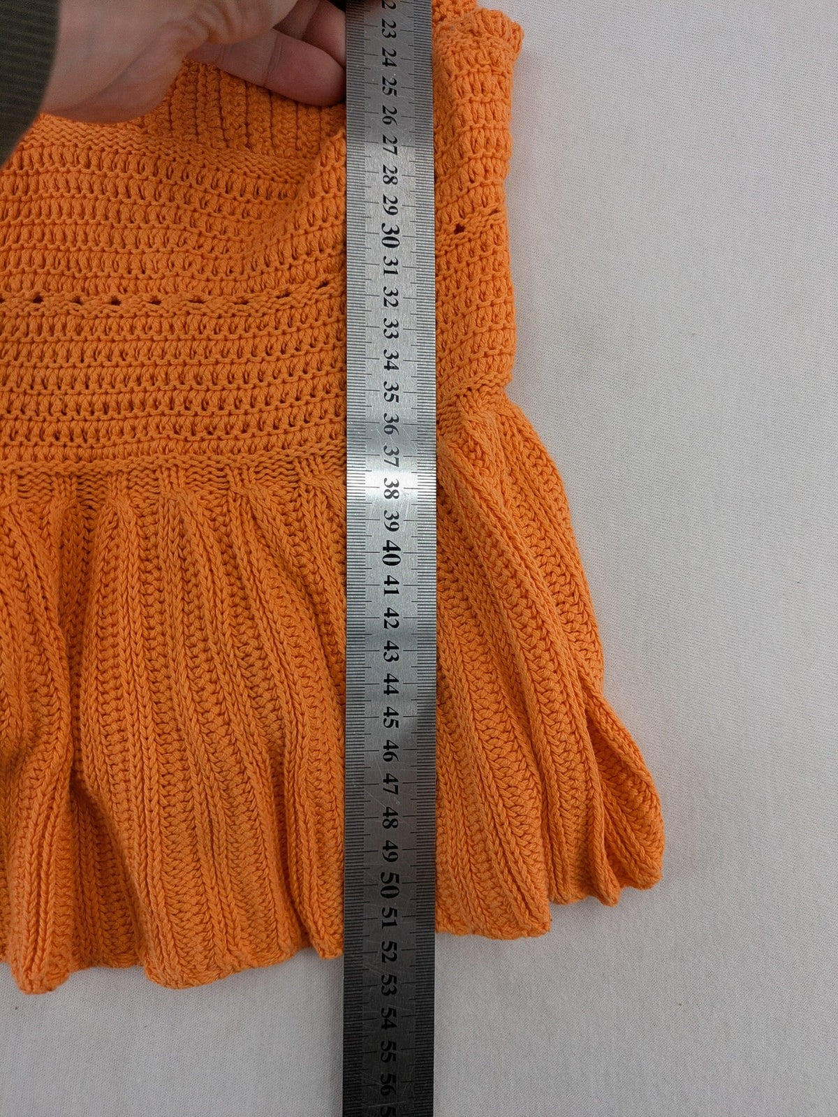 REVIEW orange crochet top with V-neck and peplum hem, made from 100% cotton.