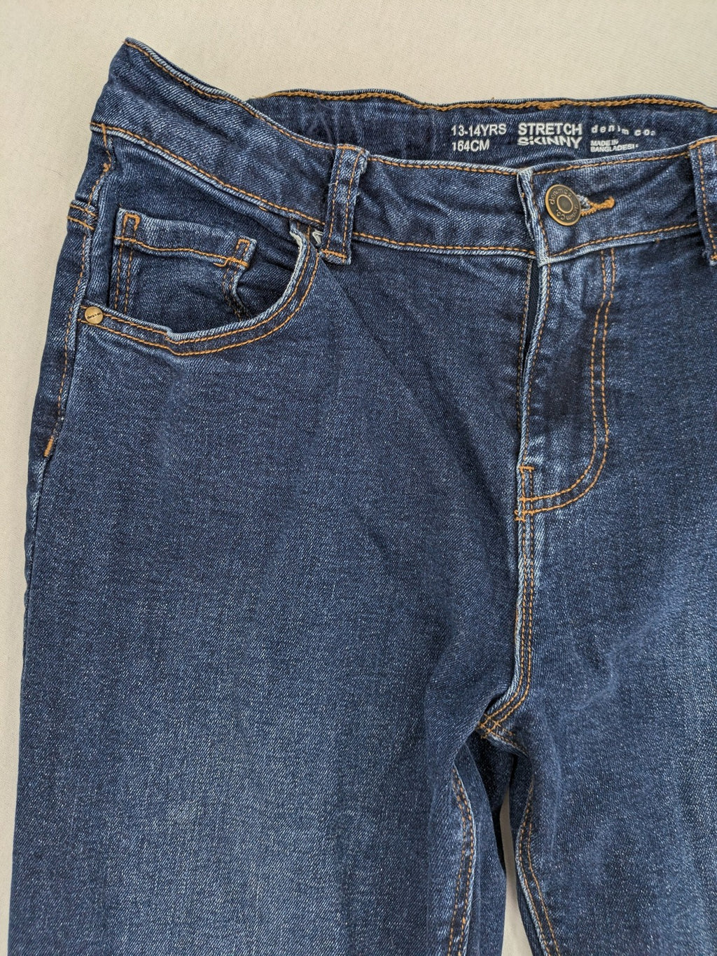 Denim & Co. blue skinny stretch jeans, five-pocket design, dark wash, durable material.