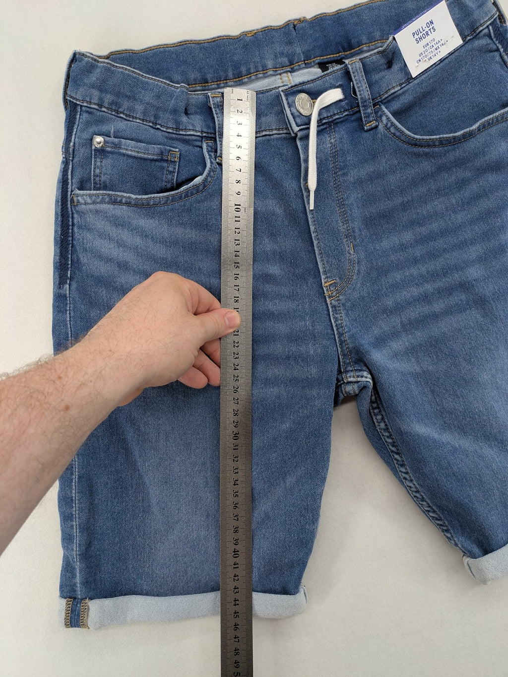 H&M blue denim shorts with adjustable drawstring, rolled hem, classic 5-pocket design.